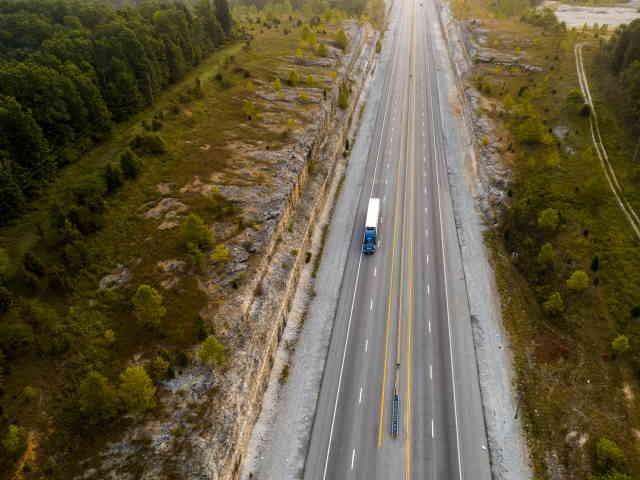 aerial view of a tractor trailer on a five lane highway