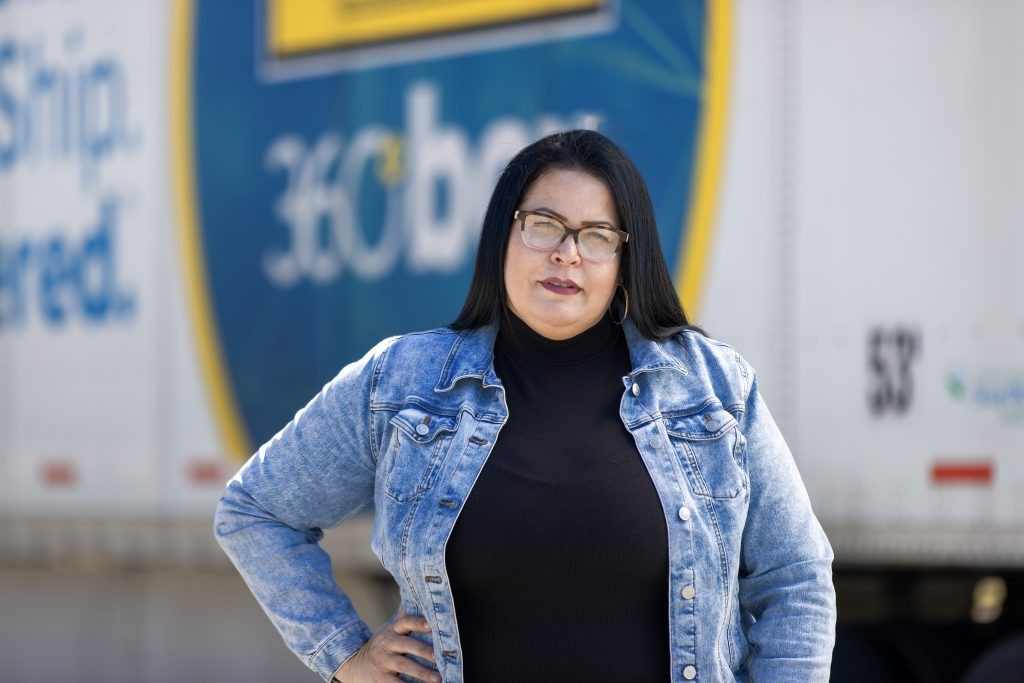 J.B. Hunt owner operator stands in front of a J.B. Hunt 360 box trailer.